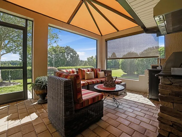 A SIDE SCREENED LANAI WITH A SUNBRELLA COVER