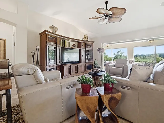 LIVING ROOM AREA WITH VIEWS TO THE ENCLOSED LANAI