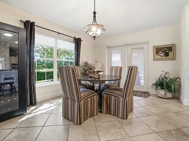 EAT IN KITCHEN WITH NATURAL SUNLIGHT POURING IN AND DOORS TO THE SIDE LANAI