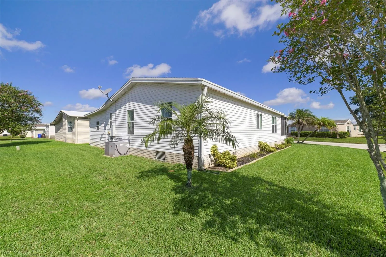 Situated on a LARGE CORNER LOT, this home offers the added benefit of NO LAND LEASE—you OWN THE LAND, along with a LOW HOA and a wonderful community atmosphere.