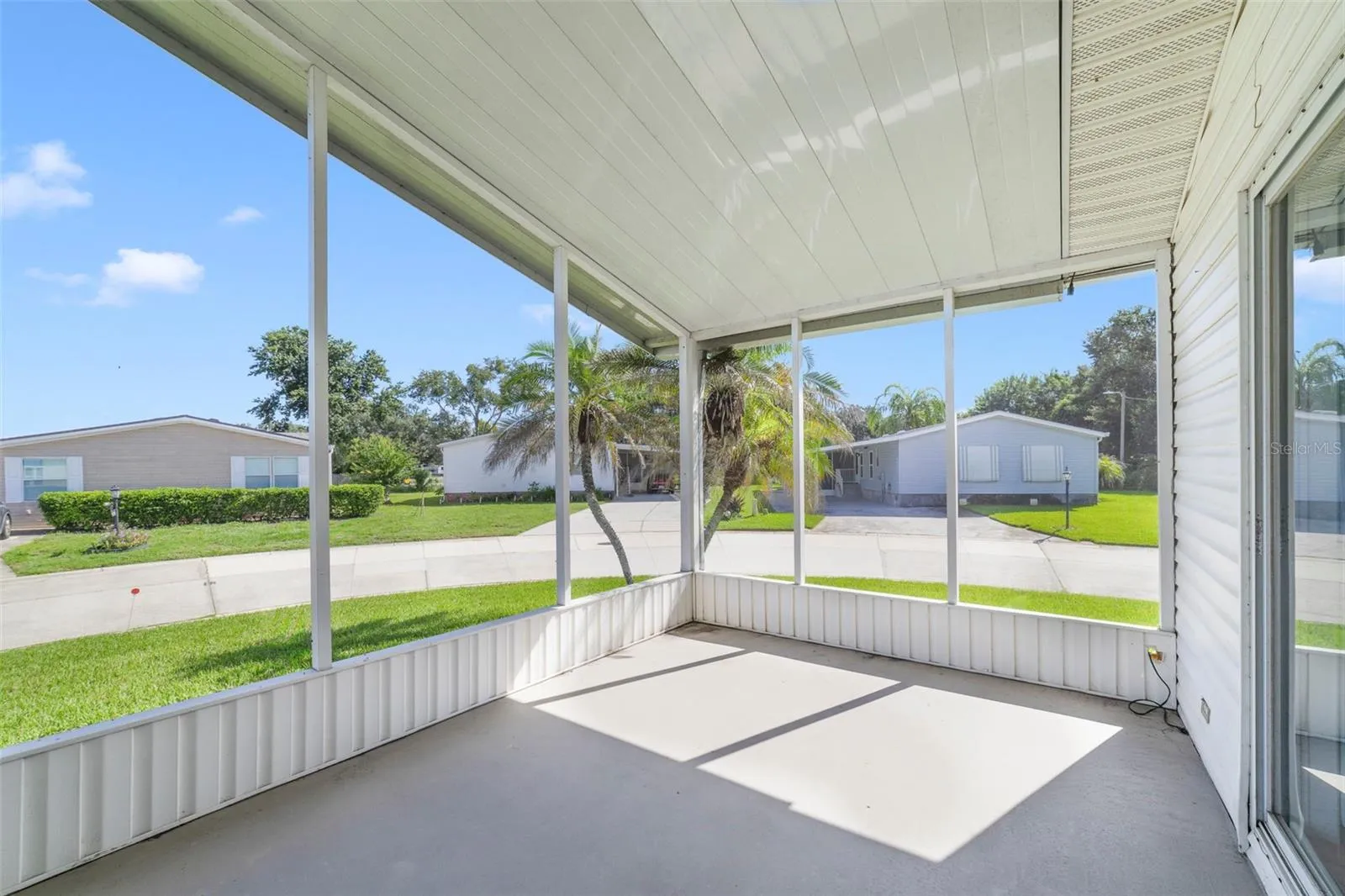 A SCREENED FRONT PORCH welcomes you home and provides a comfortable spot to enjoy your morning coffee or visit with neighbors.