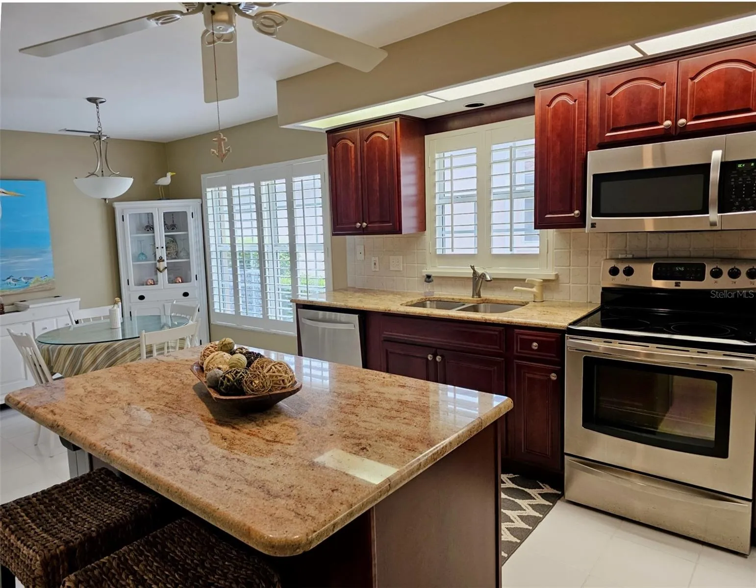 large eat-in-kitchen with ample granite countertops, center island and SS Appliances