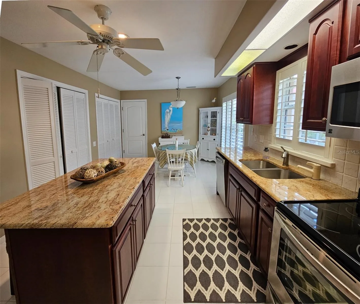 Large kitchen features granite counters, center island , wood cabinets, ample counter and closet storage. In the second closet is the washer and dryer.