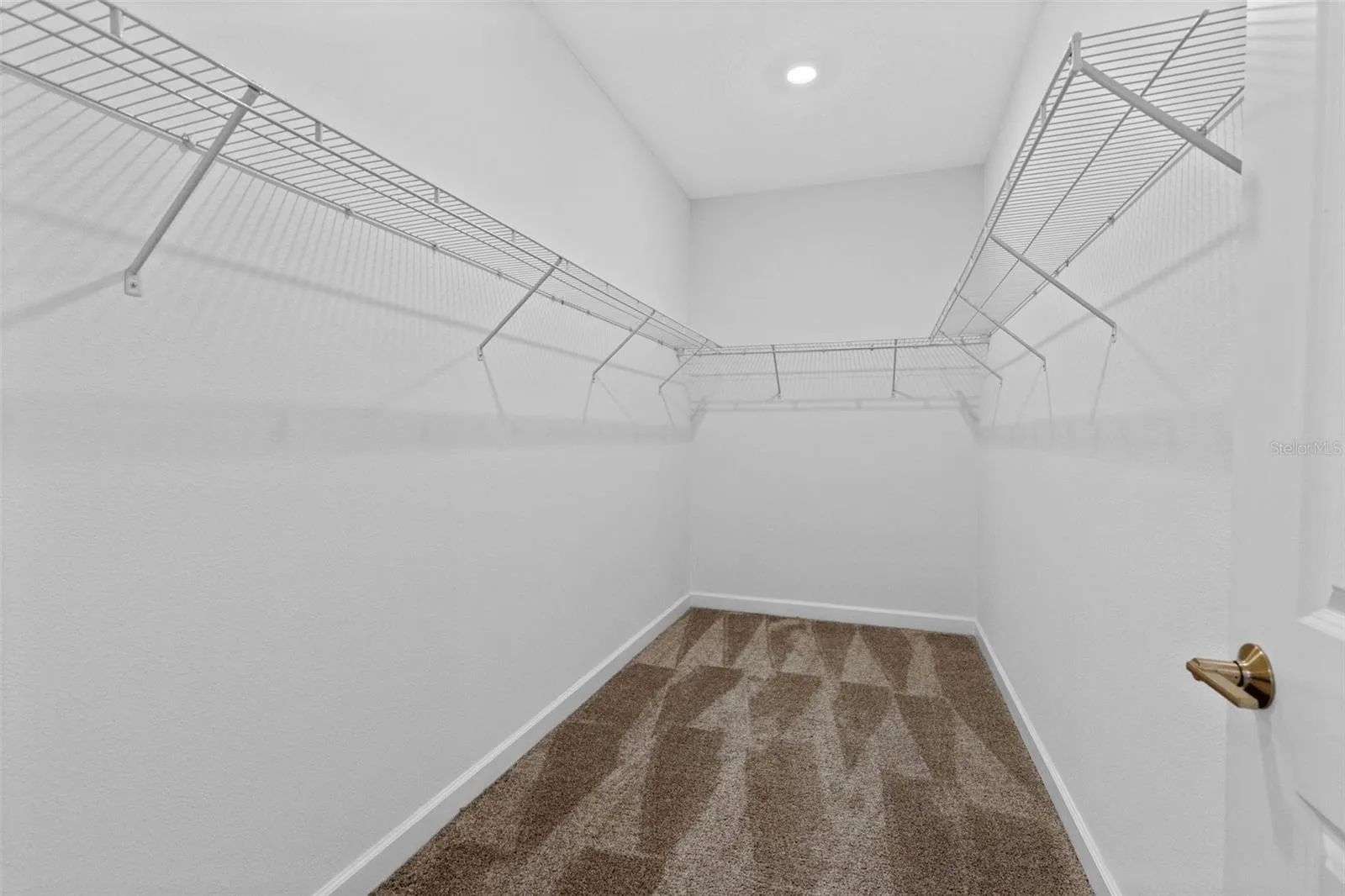 Tucked away at the rear of the home, the primary suite offers a generous walk in closet and a spacious private bathroom complete with quartz countertops, dual sinks, a soaking tub and separate shower. Direct access from the primary suite into the laundry room adds another layer of everyday convenience.