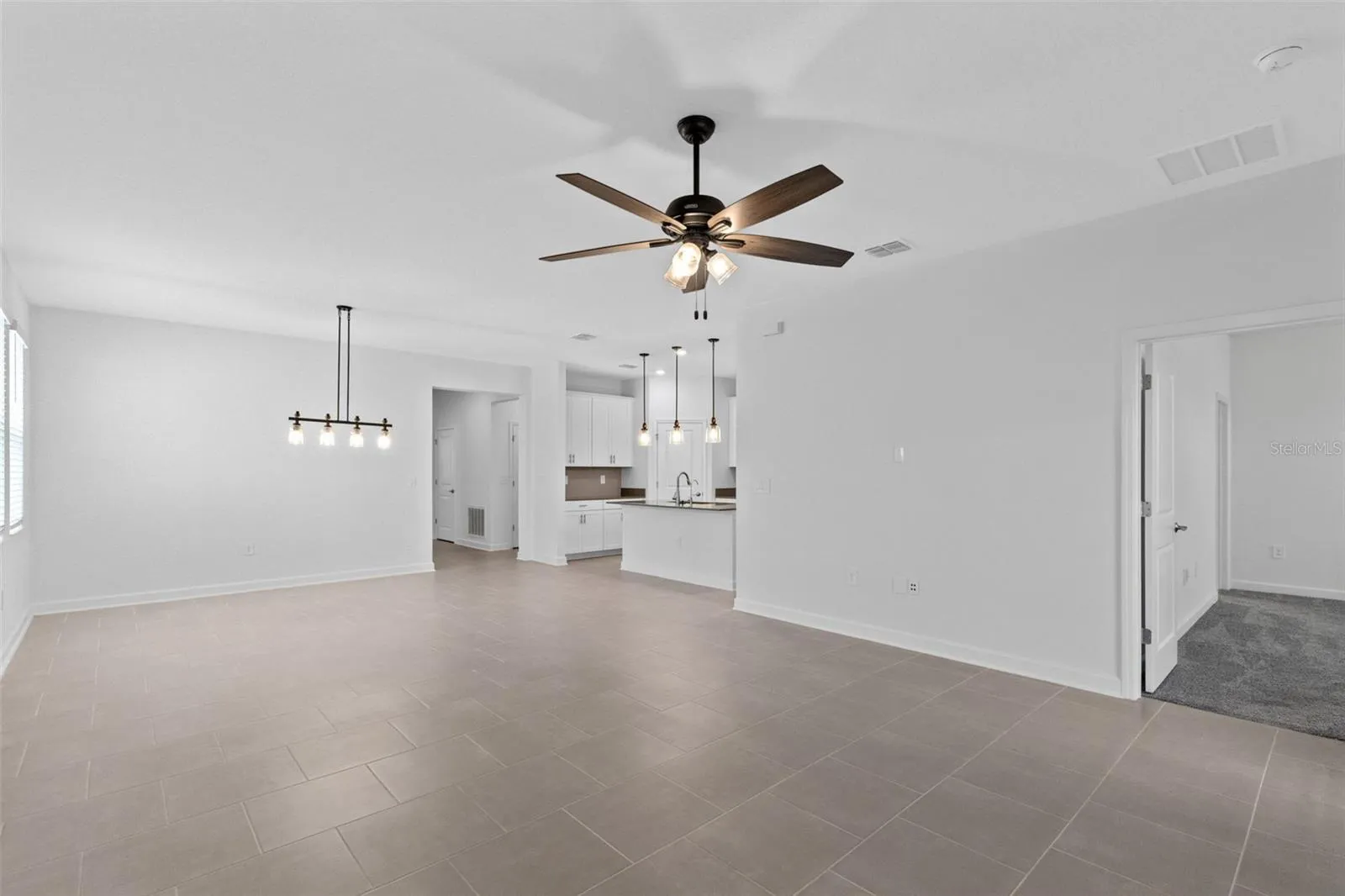 The open kitchen, dining and living spaces flow together beautifully, creating plenty of room for both everyday living and entertaining.