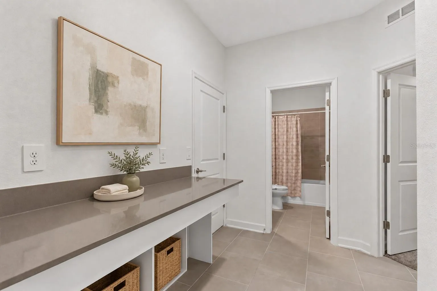 A built in desk and drop zone near the garage provide a dedicated place for homework, organization or working from home.