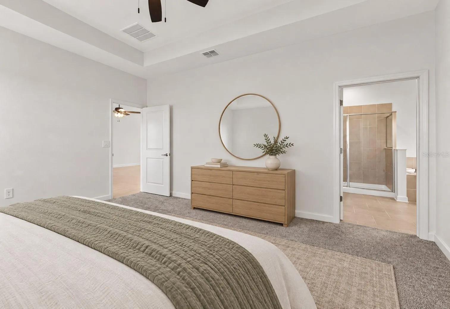 Tucked away at the rear of the home, the primary suite offers a generous walk in closet and a spacious private bathroom complete with quartz countertops, dual sinks, a soaking tub and separate shower. Direct access from the primary suite into the laundry room adds another layer of everyday convenience.