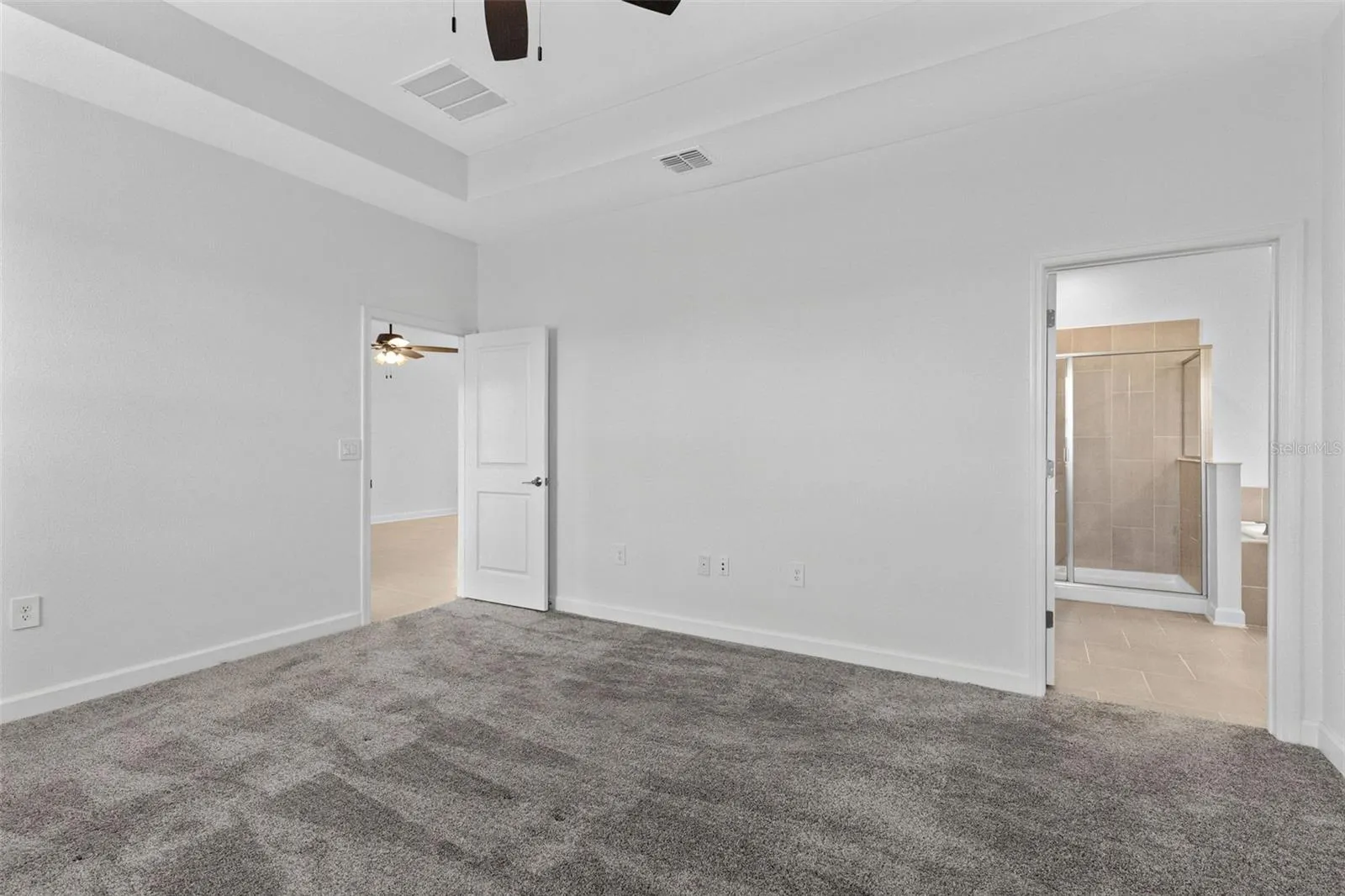 Tucked away at the rear of the home, the primary suite offers a generous walk in closet and a spacious private bathroom complete with quartz countertops, dual sinks, a soaking tub and separate shower. Direct access from the primary suite into the laundry room adds another layer of everyday convenience.