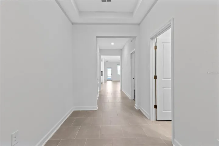 Step inside to a light and welcoming interior featuring high ceilings, a fresh neutral palette and ceramic tile throughout the main living areas.