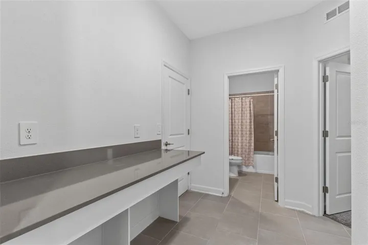 A built in desk and drop zone near the garage provide a dedicated place for homework, organization or working from home.