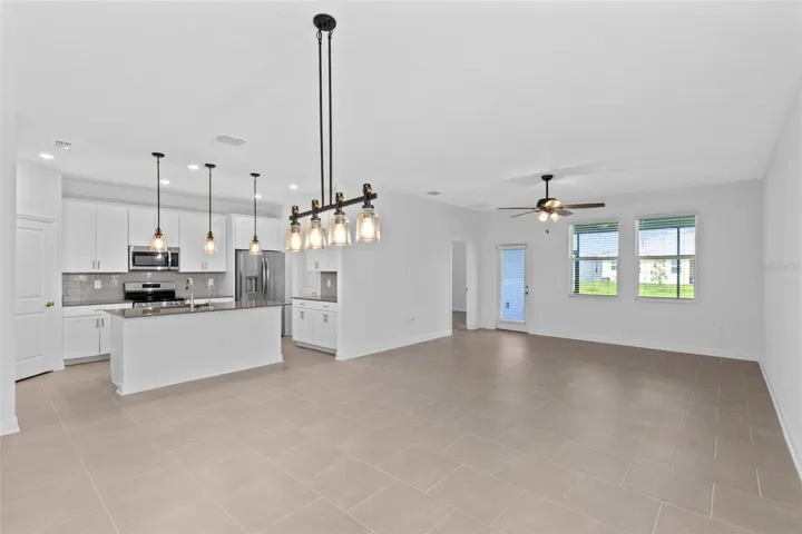 The open kitchen, dining and living spaces flow together beautifully, creating plenty of room for both everyday living and entertaining.