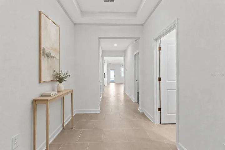 Step inside to a light and welcoming interior featuring high ceilings, a fresh neutral palette and ceramic tile throughout the main living areas.