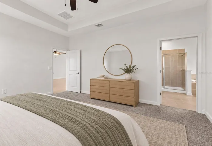 Tucked away at the rear of the home, the primary suite offers a generous walk in closet and a spacious private bathroom complete with quartz countertops, dual sinks, a soaking tub and separate shower. Direct access from the primary suite into the laundry room adds another layer of everyday convenience.
