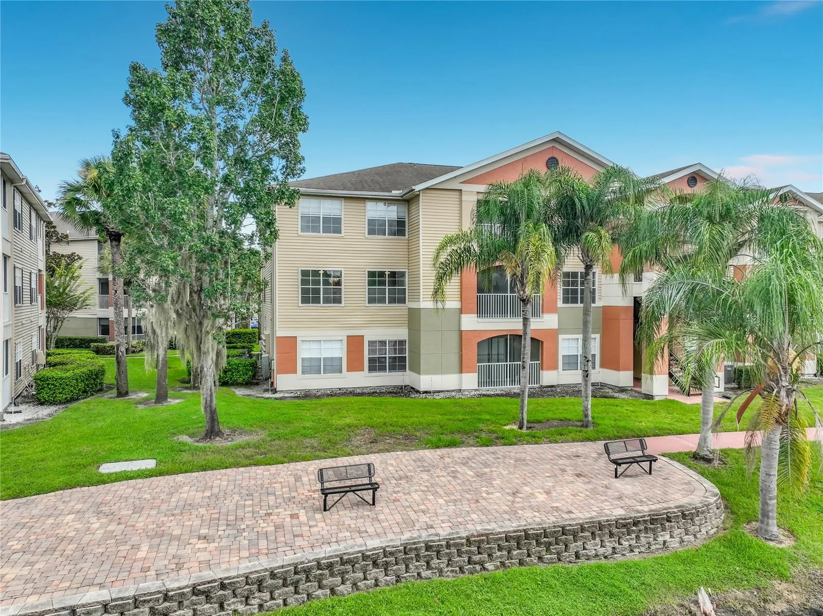 View of your corner unit overlooking the lake, benches, and walking path