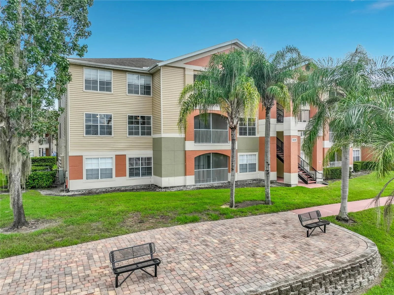 View of your corner unit overlooking the lake, benches, and walking path