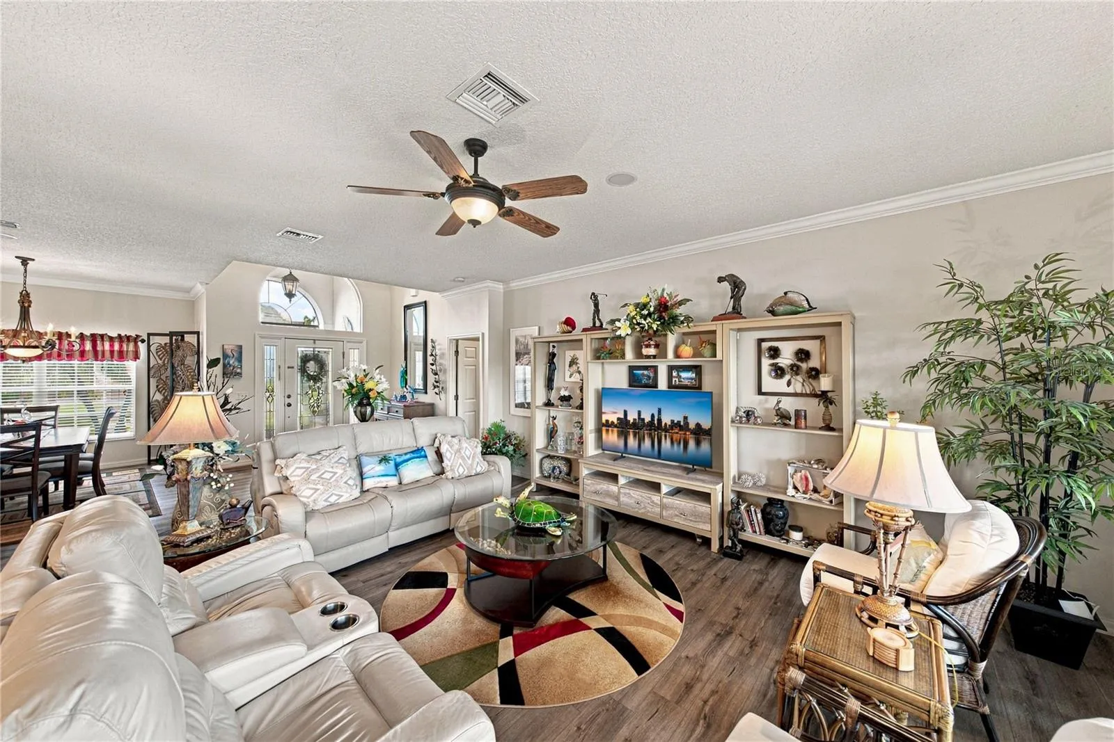 This view of the living room shows the foyer and dining room blending together.