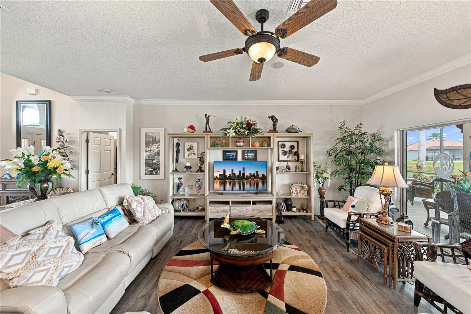 The living room has a designer ceiling fan with light.