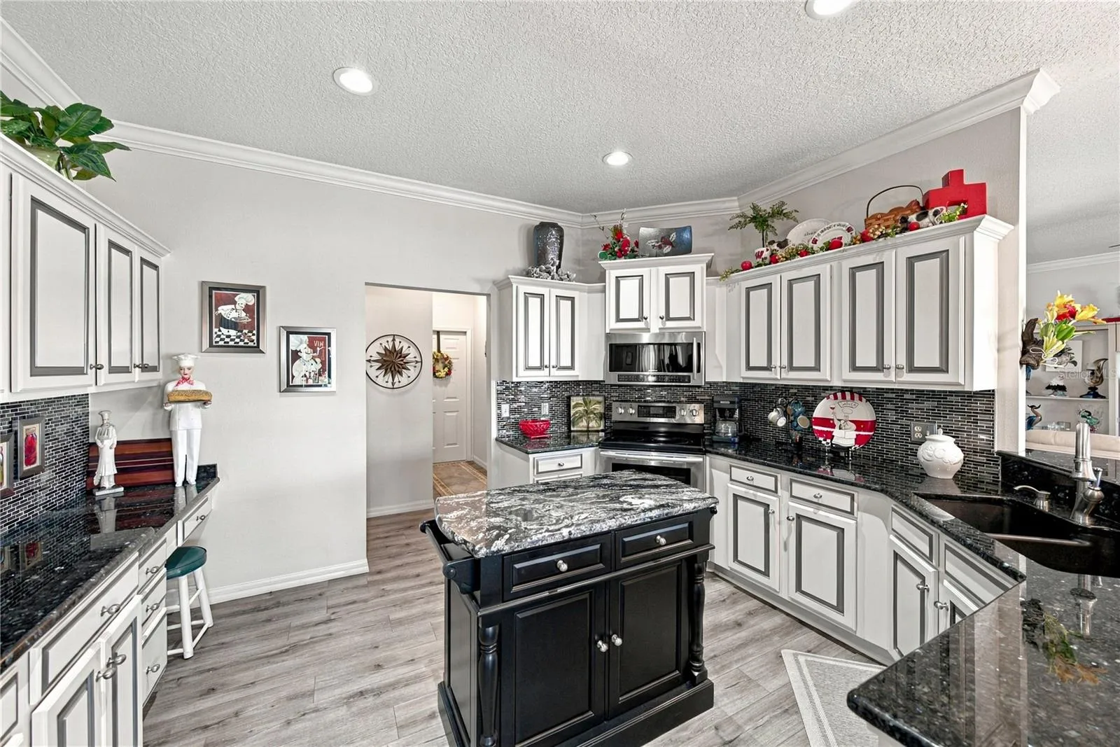 The hallway in the center of this view leads to the closet pantry, inside laundry room and the attached 2 car garage.