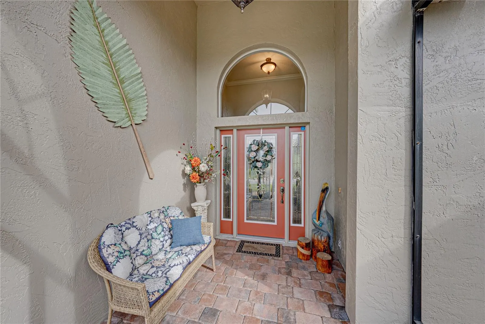 The leaded glass front door and sidelights and the large over the transom arched window provides great natural light to the welcoming foyer.