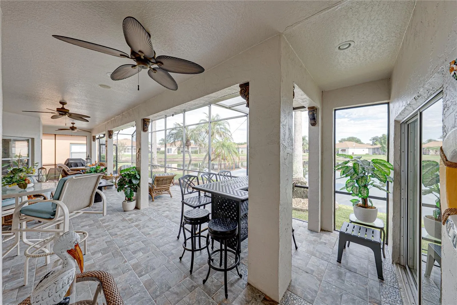 The expanded covered and bird caged lanai has ceramic tile flooring and 2 ceiling fans.