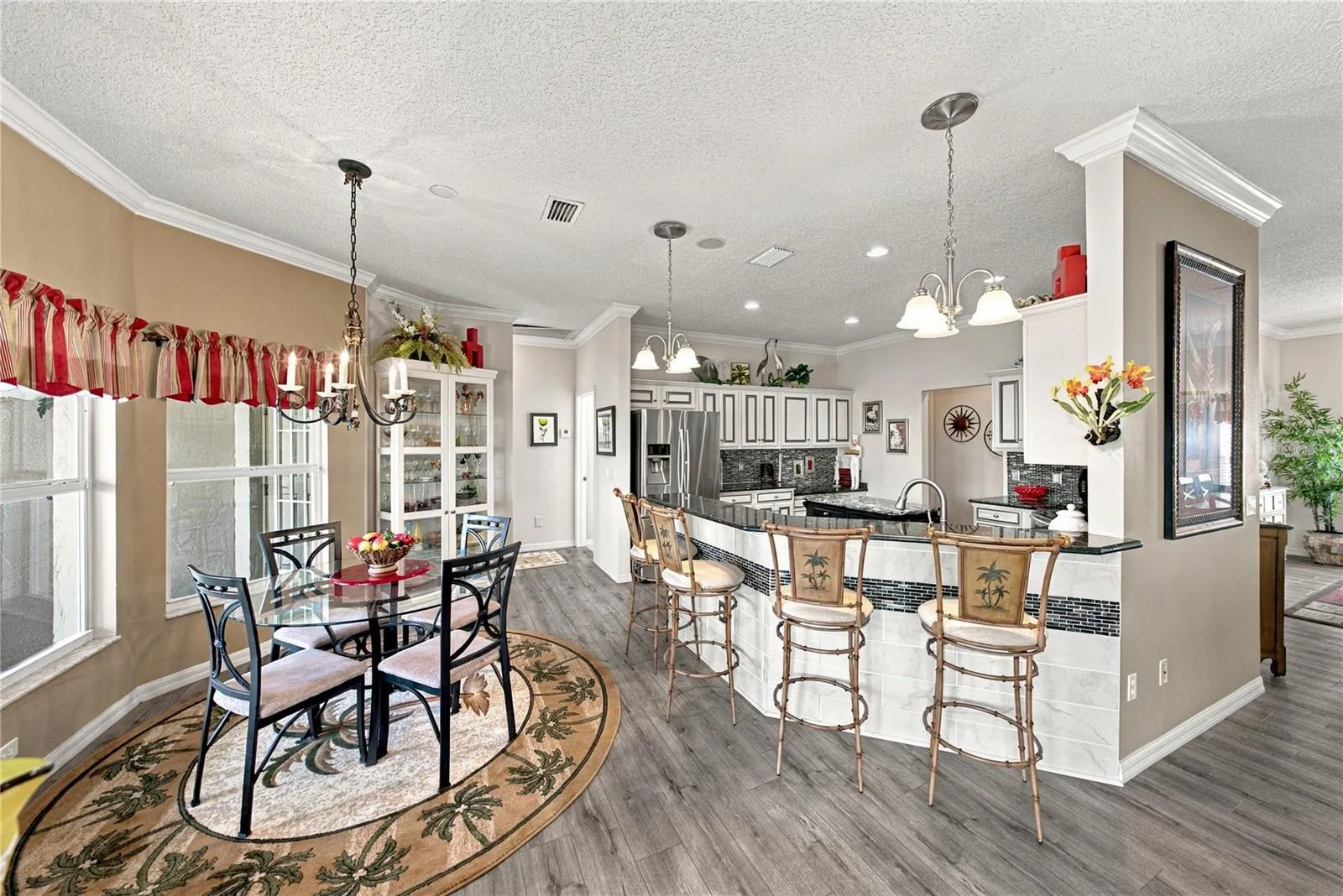 The kitchen features an elevated snack bar. The tile with accent on the snack bar wall adds beauty.