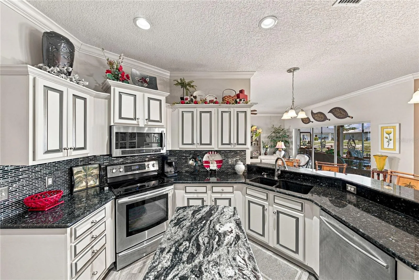 The granite countertops are enhanced by the glass backsplashes. The bank of drawers will be appreciated.