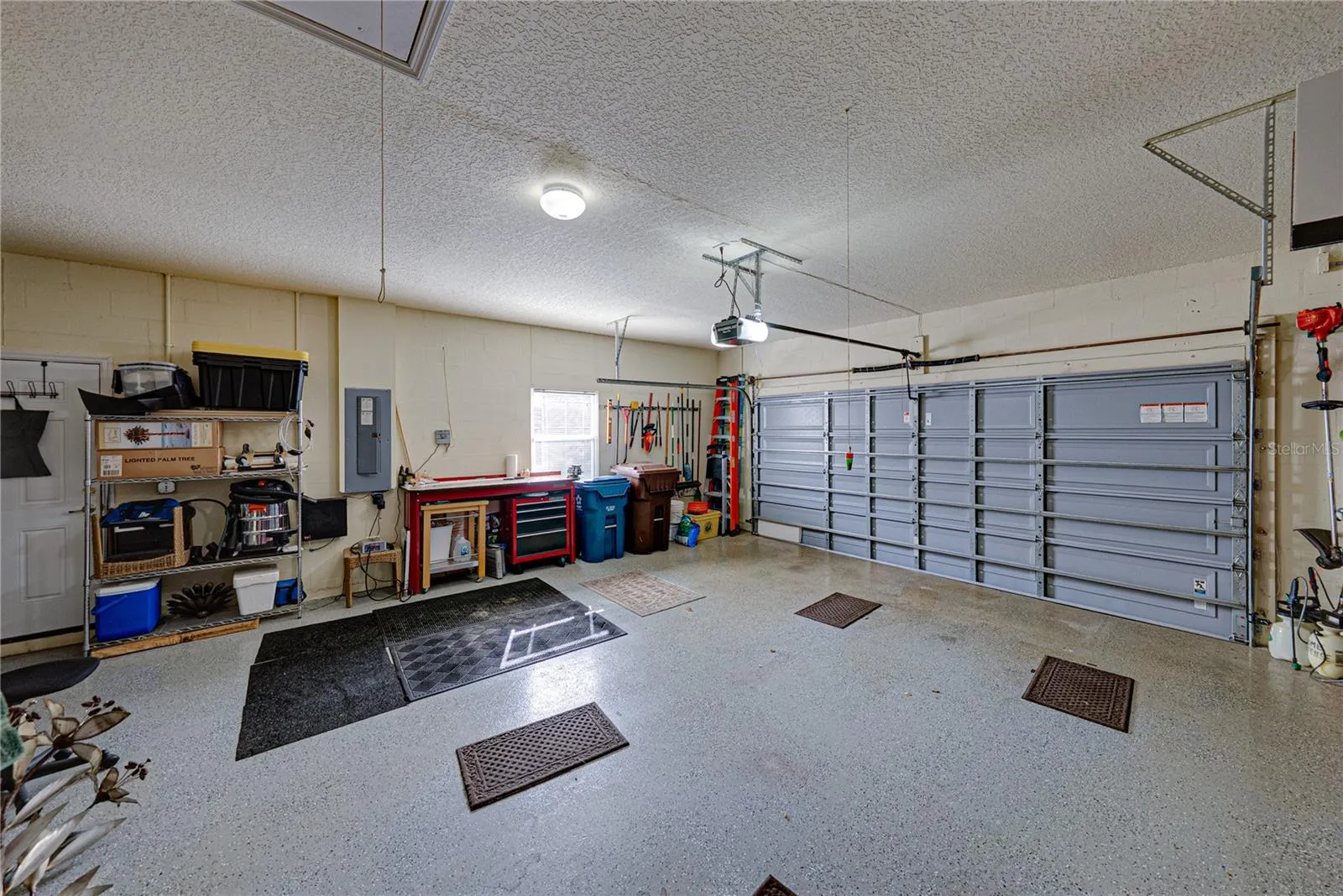 The attached 2 car garage has epoxy flooring, window, service door, and pull-down attic ladder.