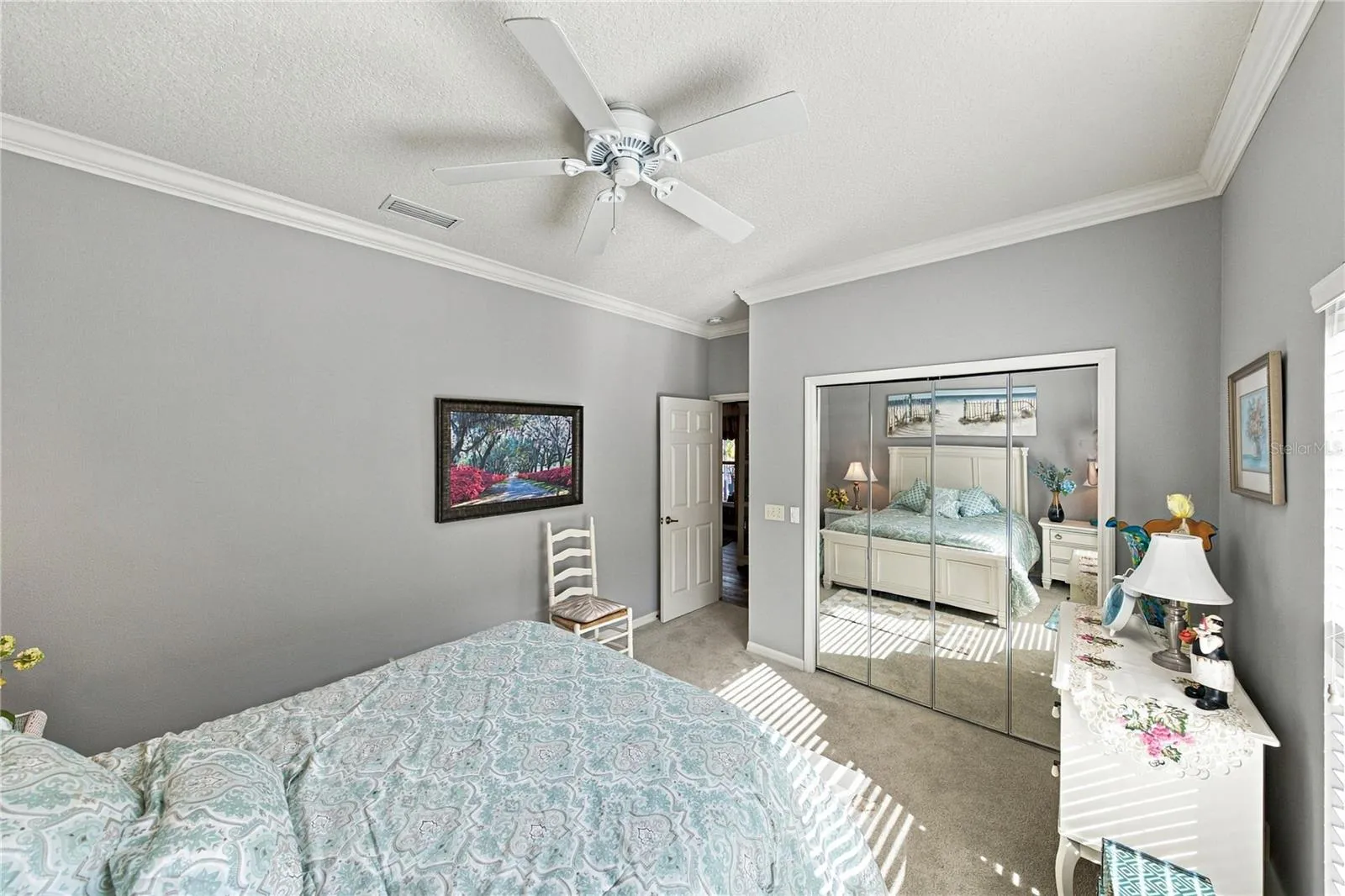 The second bedroom has mirrored closet doors. The guest bathroom is adjacent.
