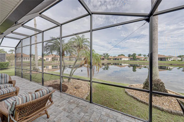 The palms, landscaping, and pond view set this home appart.