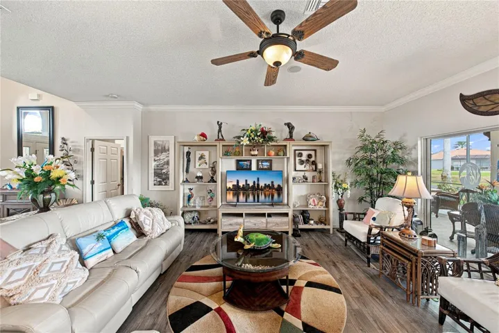 The living room has a designer ceiling fan with light.
