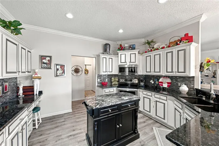 The hallway in the center of this view leads to the closet pantry, inside laundry room and the attached 2 car garage.