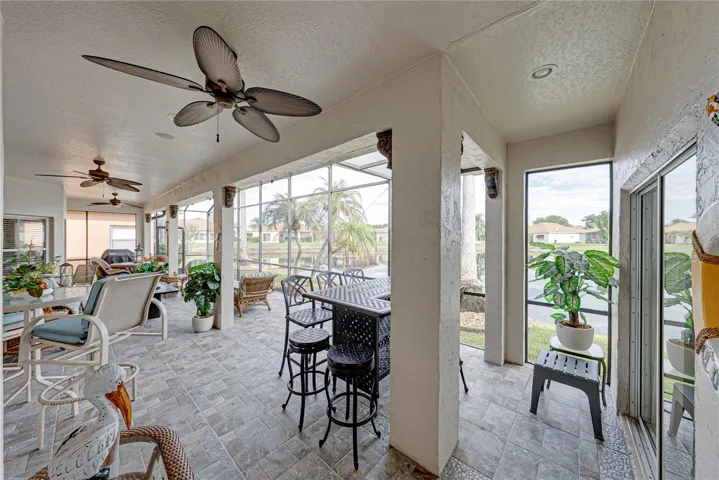 The expanded covered and bird caged lanai has ceramic tile flooring and 2 ceiling fans.