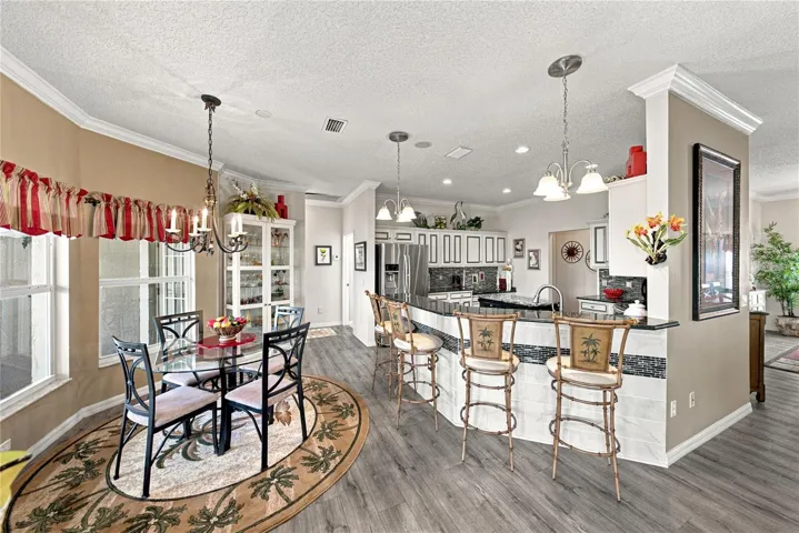 The kitchen features an elevated snack bar. The tile with accent on the snack bar wall adds beauty.
