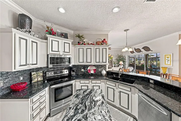 The granite countertops are enhanced by the glass backsplashes. The bank of drawers will be appreciated.