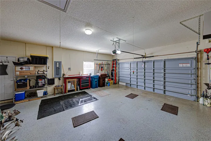 The attached 2 car garage has epoxy flooring, window, service door, and pull-down attic ladder.