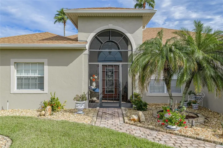 The screened covered front entry adds another place to enjoy the famous Florida climate. The screening adds a level of security while making cross ventilation a "breeze".