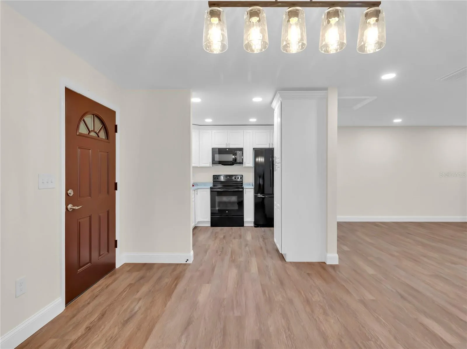 Beautiful chandelier anchors the space for a large family Table!
