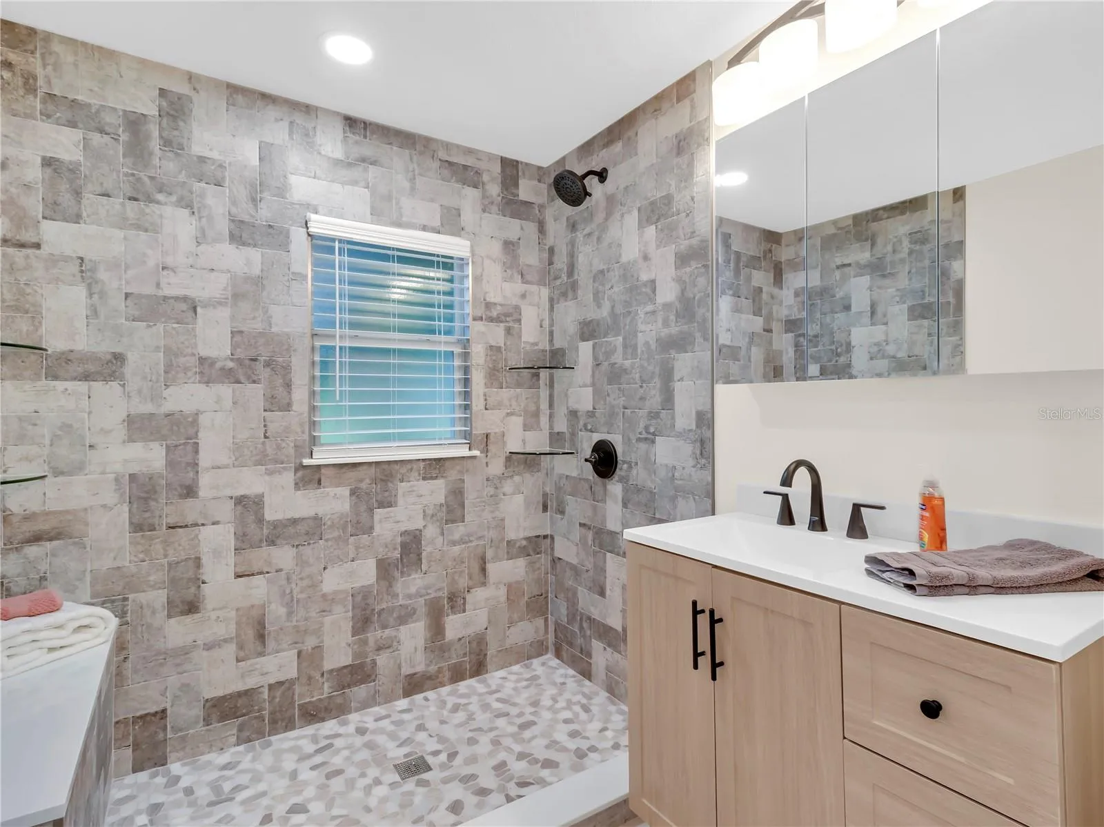 Cabinet storage , Updated lighting, Spacious shower stall with built in bench seat. Shower will have a  Glass door system installed soon!