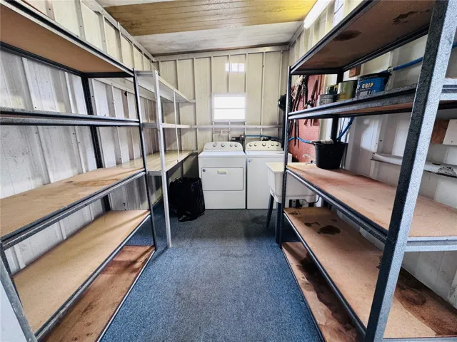 Shed with laundry and extra refrigerator.