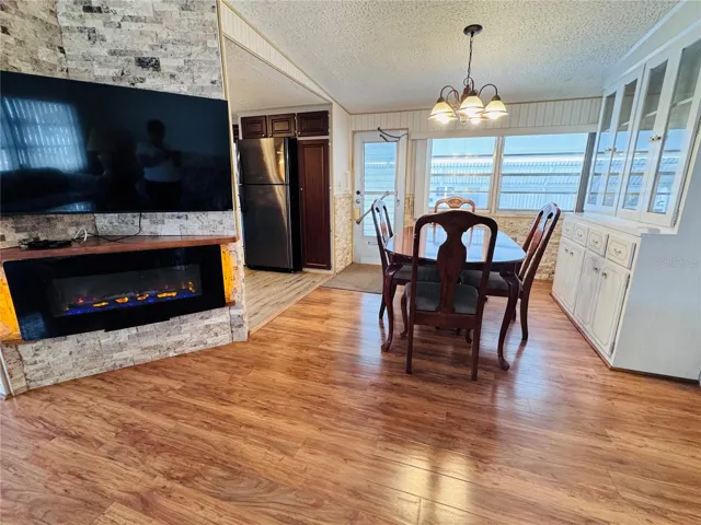 View of the dining room and built in 55 inch TV with electric fireplace.