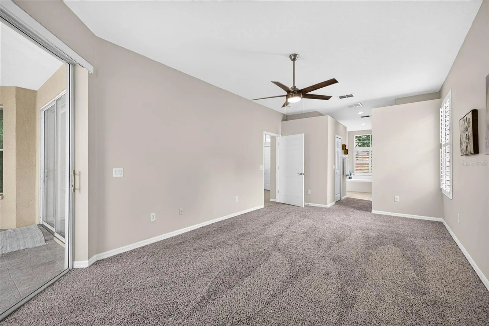PRIMARY BEDROOM WITH PRIVATE ENTRANCE OUT TO SCREEN PORCH