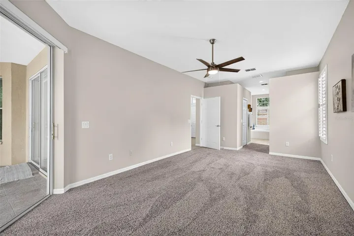 PRIMARY BEDROOM WITH PRIVATE ENTRANCE OUT TO SCREEN PORCH