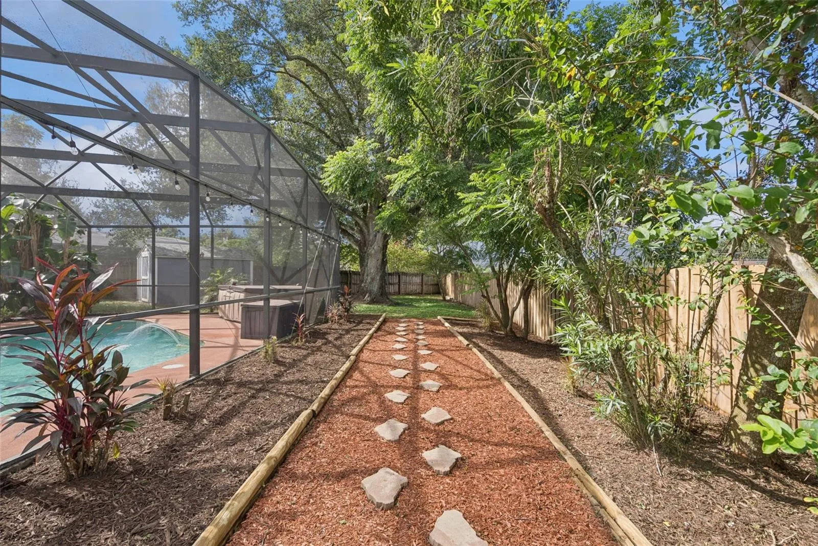 Well-Kept Landscaping Leading To A Mature Oak Tree