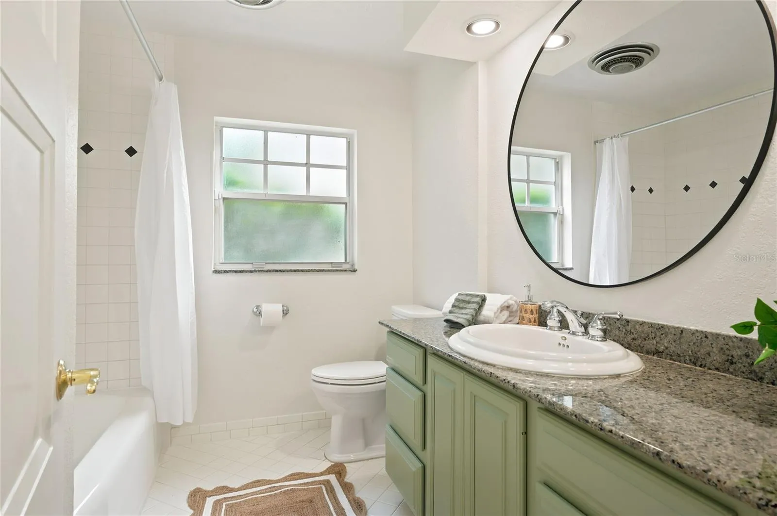Hall bath with refinished vanity & new mirror