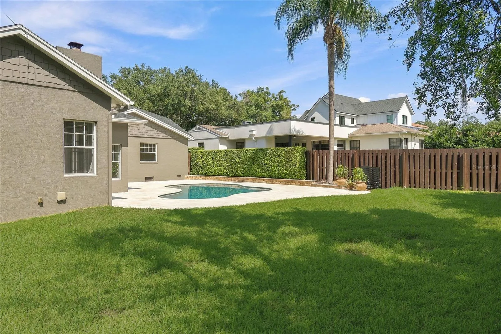 Beyond the pool, a generous stretch of lawn framed by mature trees & established landscaping adds a wonderful sense of space and privacy, with plenty of room to enjoy the backyard beyond the pool deck.