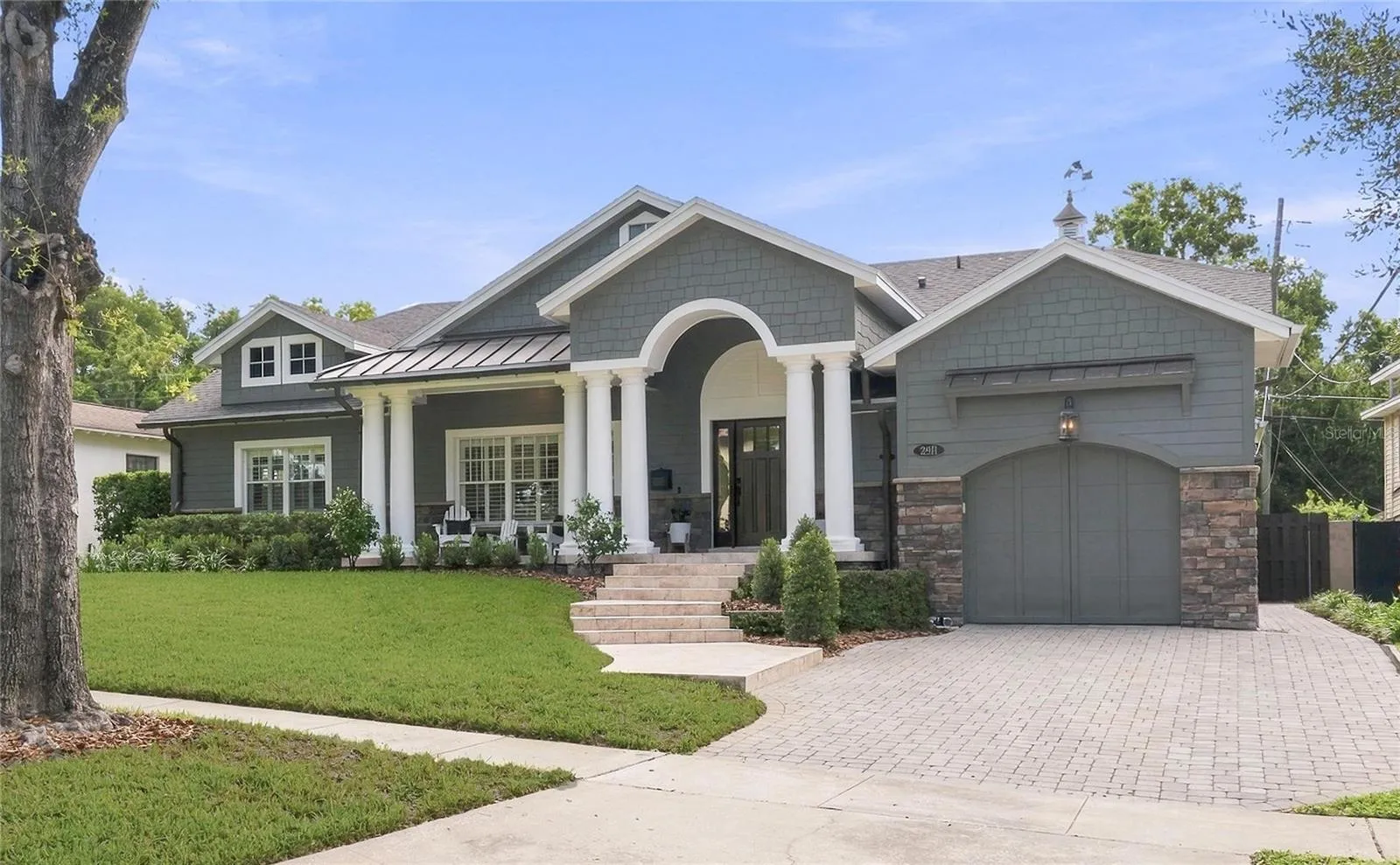 Oversized brick paver driveway offers a finished look to the exterior and convenient parking