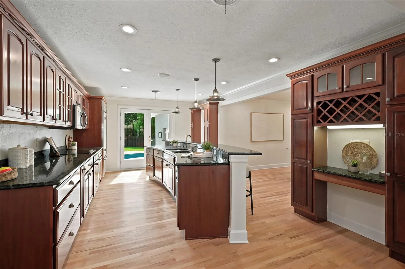 The kitchen makes a statement with its generous scale & abundance of cabinetry & a dedicated wine storage area.