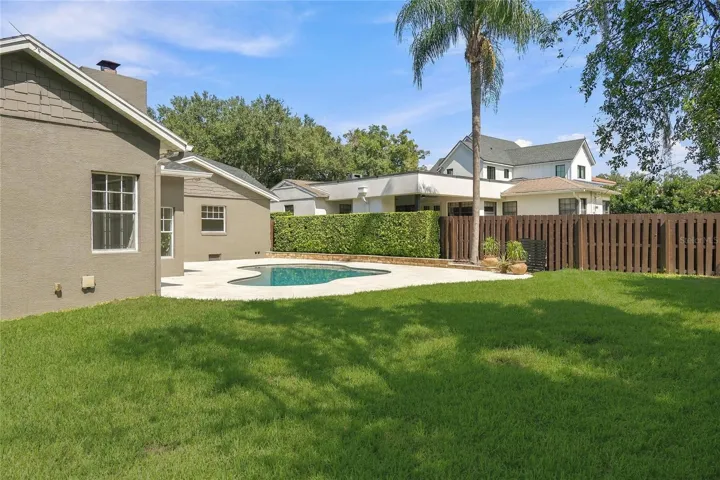 Beyond the pool, a generous stretch of lawn framed by mature trees & established landscaping adds a wonderful sense of space and privacy, with plenty of room to enjoy the backyard beyond the pool deck.