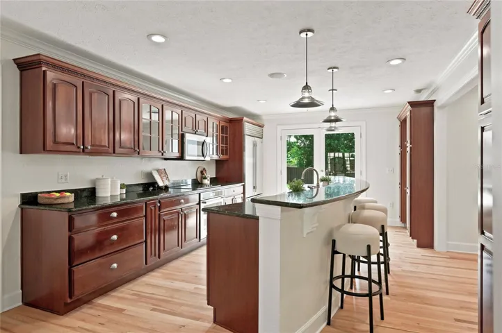 Offering exceptional storage along with glass-front display cabinets & appliances include Subzero refrigerator, Kitchenaid built-in oven and induction cooktop