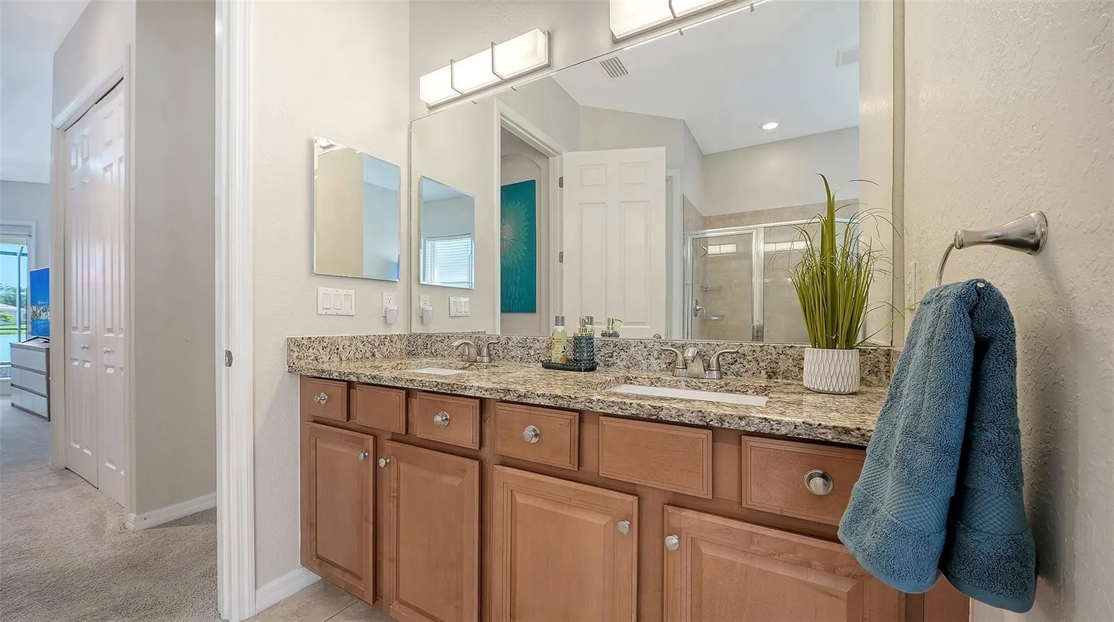 Dual sink vanity with upgraded counter, sinks, faucets and lighting